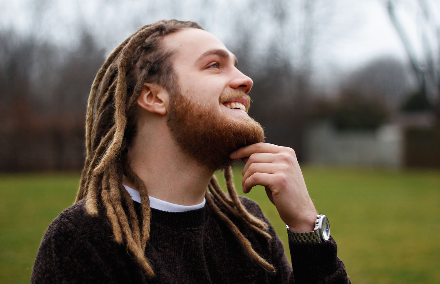 Laughing nice looking guy with dreadlocks