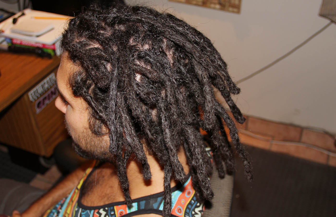 Jonathan from Quebec with Dreads. black hair in dreadlocks with a tank top.