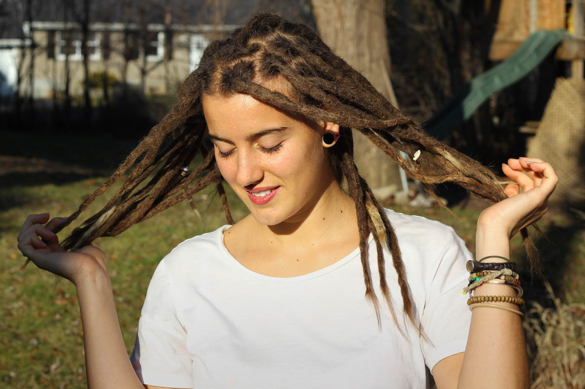 Serina, beautiful princess girl in montreal holding her sexy dreadlocks wearing lip stick. Maintains her dreadlocks at Dreads MTL.